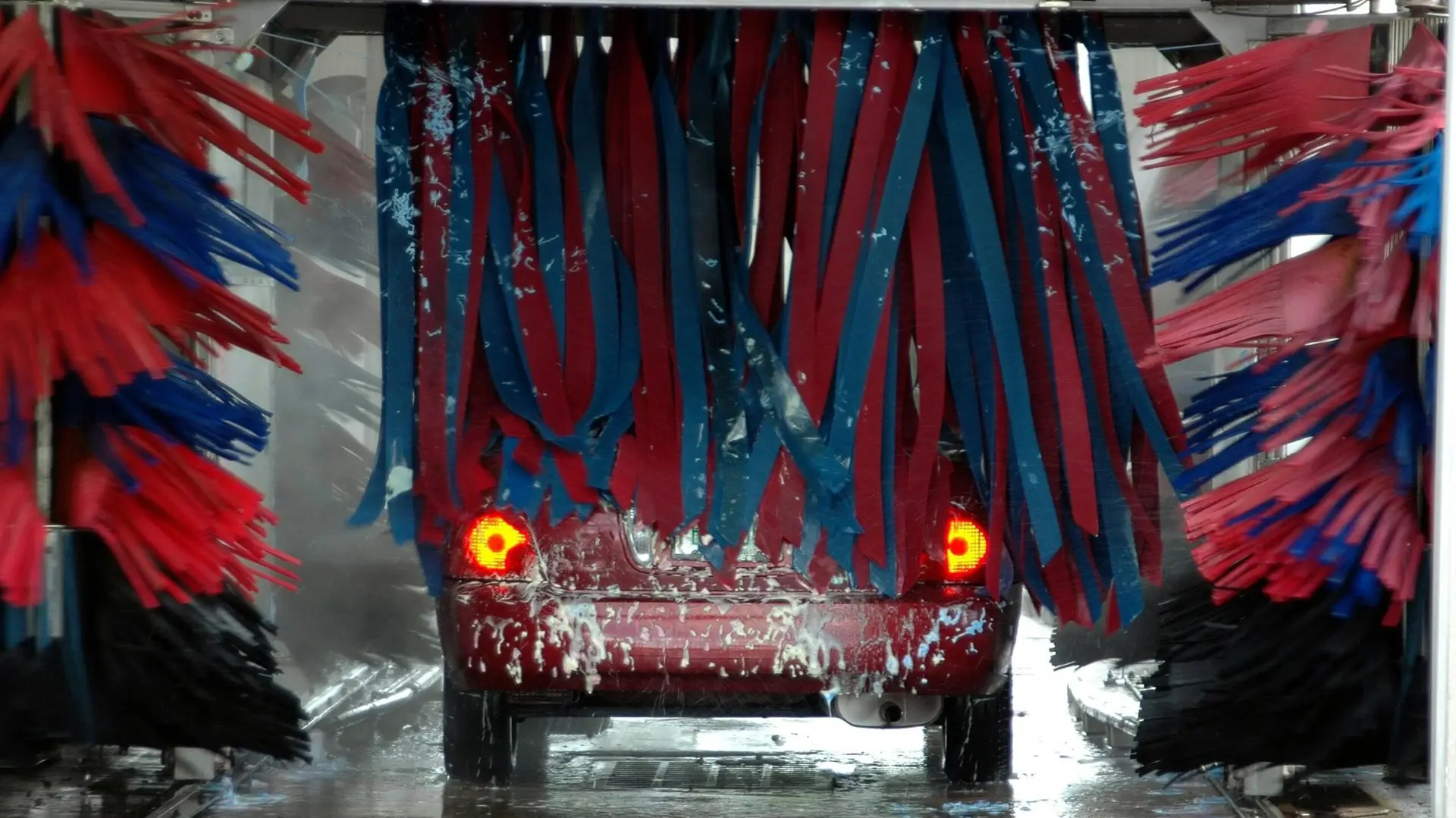 Car going through an automatic wash – comparing detail vs. automatic wash methods