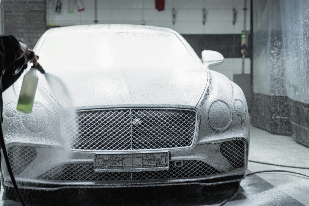 Car detailer cleaning vehicle exterior for the blog in The Woodlands, TX